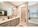 Bathroom with double sinks, neutral cabinets, bathtub and separate toilet room at 1652 Tryon Ne Rd, Atlanta, GA 30319