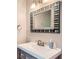 Bathroom featuring a unique mirror, a modern sink with wood accents, and stylish fixtures creating a spa-like atmosphere at 1652 Tryon Ne Rd, Atlanta, GA 30319