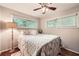Comfortable bedroom with a plush bed, lamp, and natural light from large windows at 1652 Tryon Ne Rd, Atlanta, GA 30319