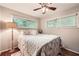 Comfortable bedroom with a plush bed, lamp, and natural light from large windows at 1652 Tryon Ne Rd, Atlanta, GA 30319