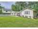 Exterior view of the property showcasing the lovely lawn and picket fence on a cloudy day at 1652 Tryon Ne Rd, Atlanta, GA 30319