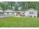 Charming single-story home with a well-manicured lawn, inviting patio, and beautiful landscaping at 1652 Tryon Ne Rd, Atlanta, GA 30319