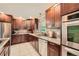 Spacious kitchen features stainless appliances, a tile backsplash, granite counters and rich wood cabinetry at 1652 Tryon Ne Rd, Atlanta, GA 30319