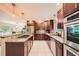 Well-equipped kitchen with stainless steel appliances, granite countertops, and dark wood cabinets for ample storage at 1652 Tryon Ne Rd, Atlanta, GA 30319
