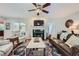 Cozy living room with hardwood floors, fireplace, ceiling fan, and comfortable seating at 1652 Tryon Ne Rd, Atlanta, GA 30319