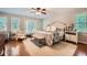 Spacious main bedroom boasts hardwood floors, natural light, a sitting area and a ceiling fan at 1652 Tryon Ne Rd, Atlanta, GA 30319