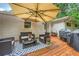 Outdoor patio features a wooden deck, patio furniture, an umbrella, and a barbecue grill at 1652 Tryon Ne Rd, Atlanta, GA 30319