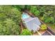 Beautiful aerial view of the home showcasing the pool and surrounding lush greenery and trees at 18 Mary Ne Ln, White, GA 30184