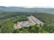 Beautiful aerial of a community with a pool, surrounded by trees and homes at 18 Mary Ne Ln, White, GA 30184