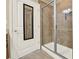 Bathroom showcasing a glass-enclosed shower and an adjacent door with a built-in mirror at 18 Mary Ne Ln, White, GA 30184