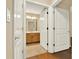 A bright bathroom seen through an open double door, featuring tile floors and vanity at 18 Mary Ne Ln, White, GA 30184