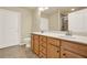 Bathroom vanity with double sinks and tile floors, adjacent to a white door and toilet at 18 Mary Ne Ln, White, GA 30184