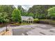 Front exterior of home surrounded by trees, driveway, and lush green spaces at 18 Mary Ne Ln, White, GA 30184