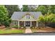 Charming home with a welcoming front porch, rocking chairs, and well-manicured landscaping at 18 Mary Ne Ln, White, GA 30184