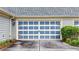 Attached garage with paneled blue and white door at 18 Mary Ne Ln, White, GA 30184