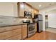 Modern kitchen with stainless steel appliances, granite countertops, tile backsplash, and wood flooring at 18 Mary Ne Ln, White, GA 30184
