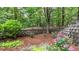 Beautiful landscaping with blooming flowers and manicured shrubbery lining a stone wall at 18 Mary Ne Ln, White, GA 30184