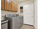 Bright laundry room featuring tile floors and spacious overhead cabinets, including washer and dryer at 18 Mary Ne Ln, White, GA 30184