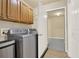Bright laundry room featuring tile floors and spacious overhead cabinets, including washer and dryer at 18 Mary Ne Ln, White, GA 30184