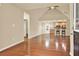 Open-concept living room with hardwood floors and a view of the modern kitchen with breakfast bar at 18 Mary Ne Ln, White, GA 30184
