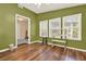 Bright sunroom with multiple windows, hardwood flooring, and serene views of the outdoors at 18 Mary Ne Ln, White, GA 30184