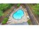 Aerial view of the kidney-shaped swimming pool with lounge chairs, perfect for summer relaxation at 18 Mary Ne Ln, White, GA 30184