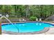 Community kidney-shaped swimming pool with a lifeguard ring and lounge chairs on a sunny day at 18 Mary Ne Ln, White, GA 30184