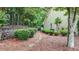 Landscaped yard with lush bushes and a charming stone path leading to the home's exterior at 18 Mary Ne Ln, White, GA 30184