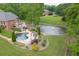 Backyard oasis featuring a gunite pool, a tranquil pond with fountain, and a spacious deck for outdoor entertaining at 2623 Lindsey Grace Ln, Buford, GA 30519
