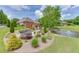 Expansive backyard featuring a kidney-shaped pool, pond, and lush landscaping to the back of the home at 2623 Lindsey Grace Ln, Buford, GA 30519
