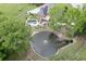 An expansive backyard featuring a serene pond with fountain, a sparkling pool, and a charming deck at 2623 Lindsey Grace Ln, Buford, GA 30519