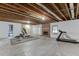 Spacious basement area with unfinished ceiling, concrete floors, and brick fireplace at 2623 Lindsey Grace Ln, Buford, GA 30519