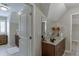 Well-lit bathroom featuring double sink vanity with granite countertop and neutral color palette at 2623 Lindsey Grace Ln, Buford, GA 30519