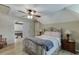 Bright bedroom with hardwood floors, ceiling fan, a plush bed and neutral paint at 2623 Lindsey Grace Ln, Buford, GA 30519
