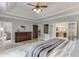 Bedroom featuring tray ceilings, an ensuite bathroom, and access to a living room at 2623 Lindsey Grace Ln, Buford, GA 30519