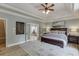 Primary bedroom with tray ceilings, and french doors leading to an ensuite bathroom at 2623 Lindsey Grace Ln, Buford, GA 30519