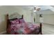 Bedroom with hardwood flooring, ceiling fan, and an iron bed frame with door at 2623 Lindsey Grace Ln, Buford, GA 30519