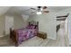 Comfortable bedroom with laminate wood flooring, ceiling fan, and iron bed frame at 2623 Lindsey Grace Ln, Buford, GA 30519