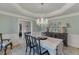 Formal dining area with a chandelier, light blue walls and white trim, creating an elegant and inviting ambiance at 2623 Lindsey Grace Ln, Buford, GA 30519