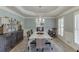 Elegant dining room featuring a chandelier, wainscoting, and ample natural light perfect for gatherings at 2623 Lindsey Grace Ln, Buford, GA 30519