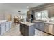 Stylish kitchen with gray cabinets, stainless steel appliances, and a butcher block island, combining functionality and design at 2623 Lindsey Grace Ln, Buford, GA 30519