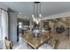 The bright kitchen showcases gray cabinets, stainless steel appliances and a wood table at 2623 Lindsey Grace Ln, Buford, GA 30519