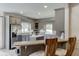 A well-lit kitchen with gray cabinets, granite countertops, and stainless-steel appliances at 2623 Lindsey Grace Ln, Buford, GA 30519