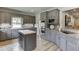 A modern kitchen featuring gray cabinetry, a center island, and stainless steel appliances at 2623 Lindsey Grace Ln, Buford, GA 30519