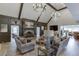 Bright living room with high ceilings, statement chandeliers, fireplace, and comfortable seating at 2623 Lindsey Grace Ln, Buford, GA 30519