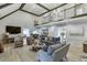 Open-concept living room with soaring ceilings, a balcony, and views of the dining area at 2623 Lindsey Grace Ln, Buford, GA 30519