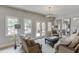 Bright living room with white brick walls, modern lighting, and access to the outdoor patio at 2623 Lindsey Grace Ln, Buford, GA 30519