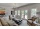 Living room with a neutral palette, access to the backyard, and comfortable wicker seating at 2623 Lindsey Grace Ln, Buford, GA 30519