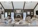 A living room showcasing a stone fireplace, high ceilings, and traditional decor at 2623 Lindsey Grace Ln, Buford, GA 30519
