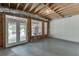 Unfinished room offering lots of light, unfinished ceiling, white painted brick, and a concrete back patio at 2623 Lindsey Grace Ln, Buford, GA 30519